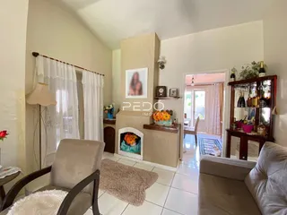 Sala de estar com piso de cerâmica clara e decoração de parede.