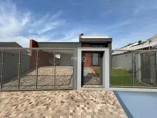 Vista da fachada de uma residência moderna com área externa cercada.
