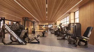 Foto do interior de uma academia com equipamentos de ginástica.