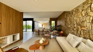 Ambiente de sala de estar e jantar com paredes de pedra e painéis de madeira.