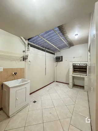 Interior de um banheiro com piso de cerâmica claro.