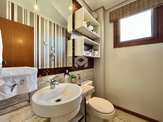 Foto de um banheiro com pia e vaso sanitário em uma residência.