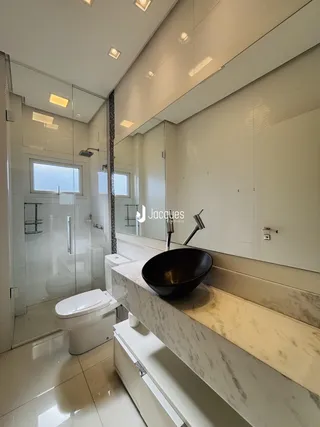 Foto de um banheiro moderno com revestimento branco e bancada de mármore.