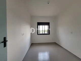 Corredor com paredes brancas e piso de cerâmica.