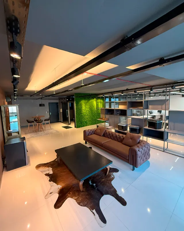 Sala de estar moderna com piso claro e parede verde em um imóvel em Lajeado.