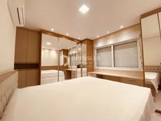 Quarto com cama e espelho em ambiente interno.