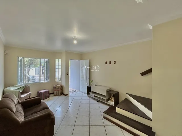 Sala de estar com piso de cerâmica e sofá no interior de uma residência.