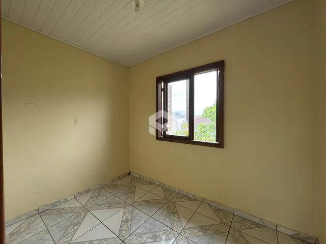 Uma sala interna com piso de cerâmica e uma janela é visível.