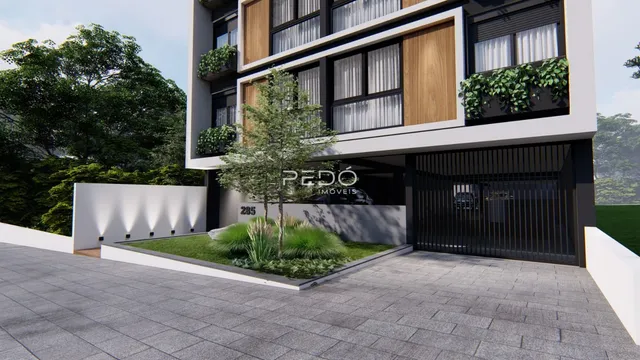 Fachada de um prédio residencial em Lajeado, Brasil, com jardim frontal e portão de entrada.