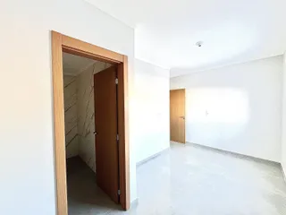 Corredor interno com portas de madeira e paredes brancas.