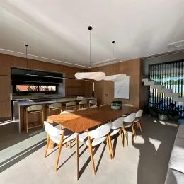 Foto de um ambiente de jantar com mesa de madeira e cadeiras brancas.