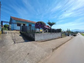Fachada de uma residência em Lajeado, Brasil, com cerca e paisagismo.