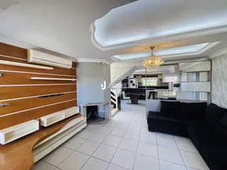 Ambiente interno de sala com parede de madeira e lareira em Lajeado.