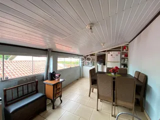 Imagem de uma sala com piso de cerâmica e mobiliário de madeira.