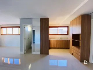 Ambiente interno claro com painéis de madeira e janelas.