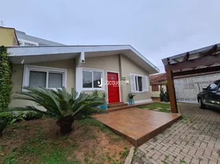 Fachada de uma residência em Lajeado, Brasil, com deck de madeira na frente.