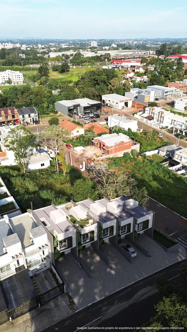 Vista aérea de uma propriedade residencial com área verde e construções ao redor.