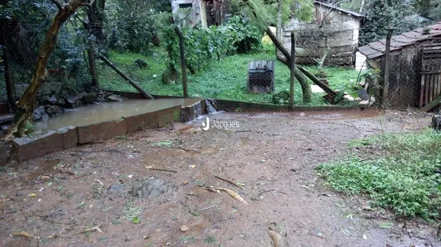 Vista da propriedade mostrando um riacho e vegetação ao redor.