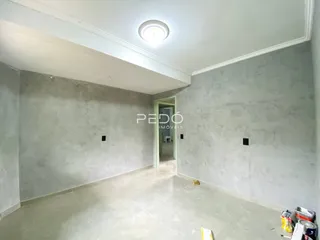 Foto de um ambiente interno com paredes de concreto aparente.