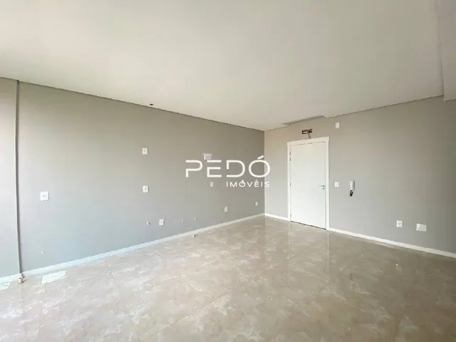 Interior de um ambiente com paredes cinzas e piso claro.