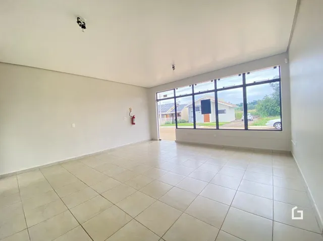 Uma sala ampla com piso de cerâmica e grande janela.