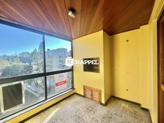 Vista ampla de um ambiente interno com grande janela que oferece uma paisagem urbana.