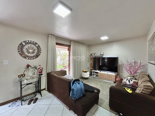 Sala de estar com sofá e televisão em um imóvel no Brasil.