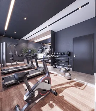 Foto de uma sala de academia com equipamentos de treino.