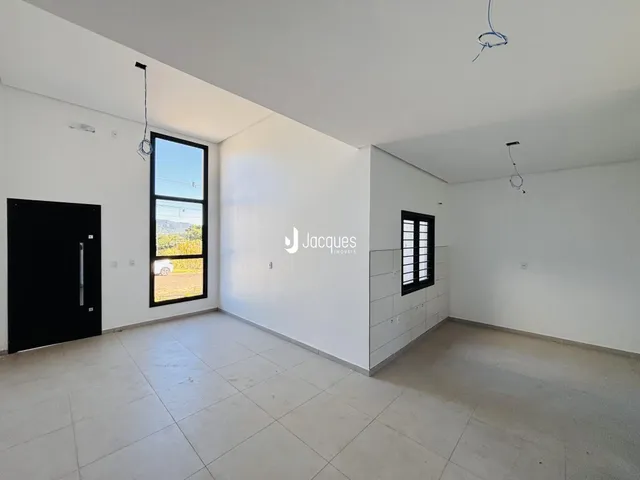 Ambiente interno de uma sala com piso de cerâmica e grande janela.