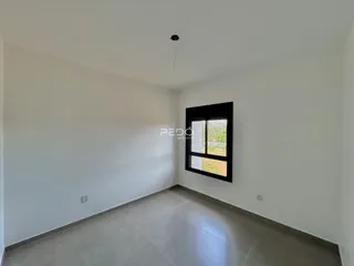 Vista interna de um cômodo com paredes brancas e piso claro.