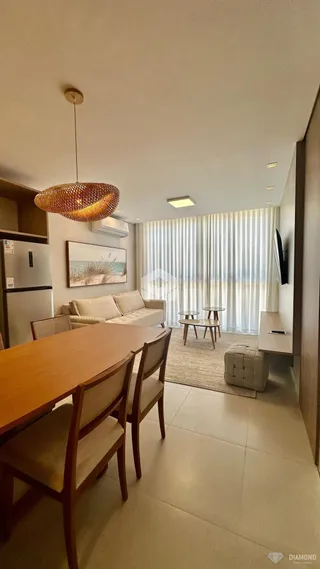 Sala de estar com mesa de jantar de madeira e sofá.