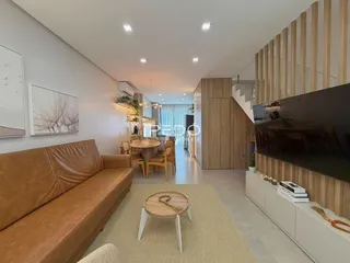 Sala de estar com sofá marrom e decoração moderna em um imóvel no Brasil.