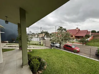 Vista externa de uma propriedade residencial em Lajeado, Brasil, mostrando o jardim e a cerca.