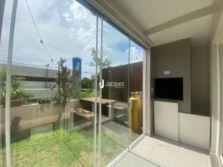 Vista da sala de estar com acesso ao quintal através de grandes portas de vidro.