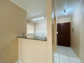 Hall de entrada com paredes claras e piso de cerâmica.