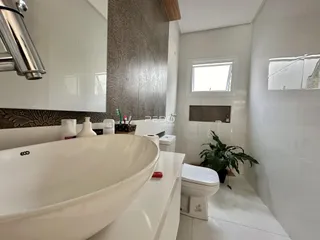 Foto de um banheiro moderno com pia de apoio e vaso sanitário.