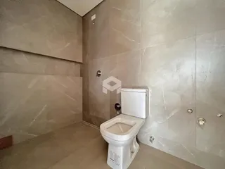 Foto de um banheiro com revestimento de azulejo claro.