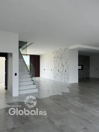 Interior de um espaço com escadaria e parede de destaque em Lajeado.