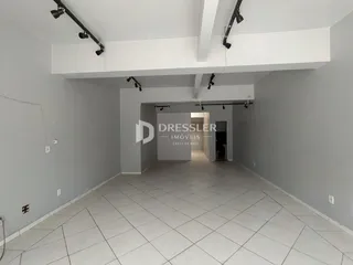 Hall de entrada com piso de cerâmica e paredes brancas.