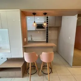 Foto de uma área de cozinha com armários e bancada de madeira.