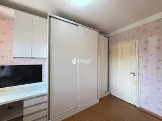 Quarto com armários embutidos e piso de madeira clara.