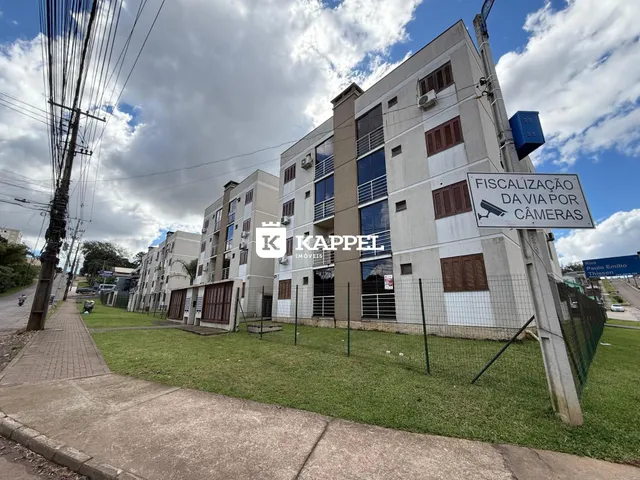 Fachada de um prédio residencial de vários andares em Lajeado, Brasil, com área gramada na frente.