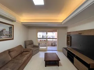 Foto de uma sala de estar com sofá e mesa de centro em um apartamento.