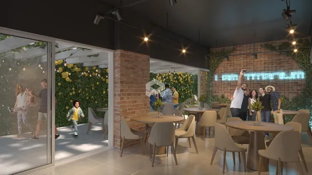 Interior de um espaço com paredes de tijolo aparente e decoração verde.