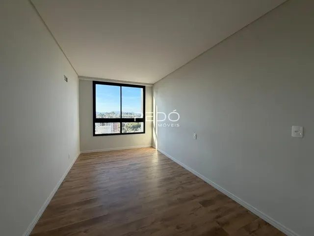 Sala de estar com piso de madeira e vista da cidade.