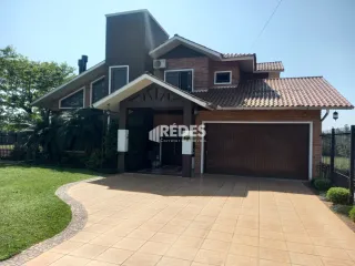 Fachada de uma residência com garagem e jardim em Lajeado, Brasil.