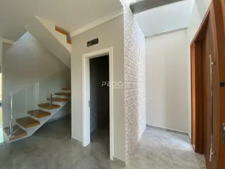 Hall de entrada com escadaria em um ambiente residencial.