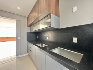 Foto de uma cozinha moderna com armários e bancada escura.