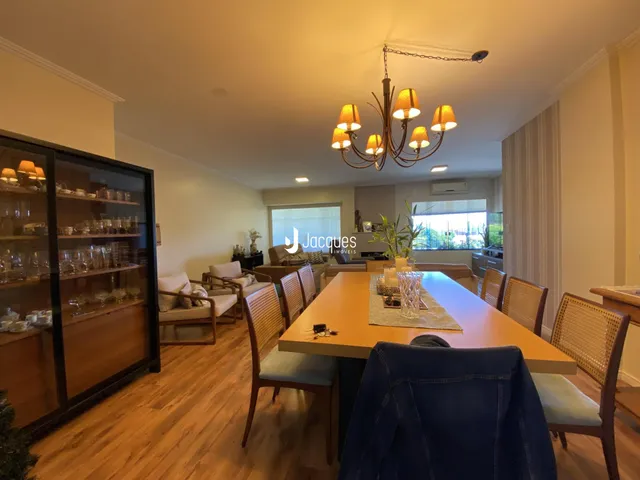 Sala de jantar com piso de madeira e móveis de madeira.