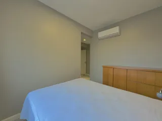 Quarto com cama grande e armário de madeira.